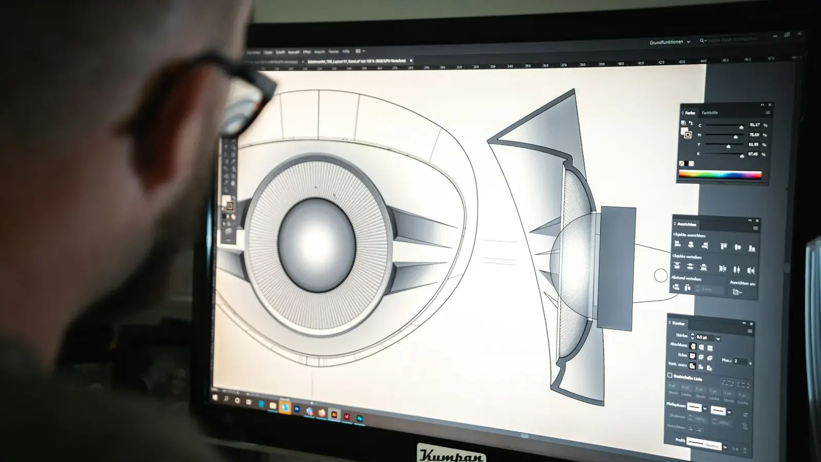 Ein Designer zeichnet Vektorgrafik am Monitor, aufgenommen über die Schulter.