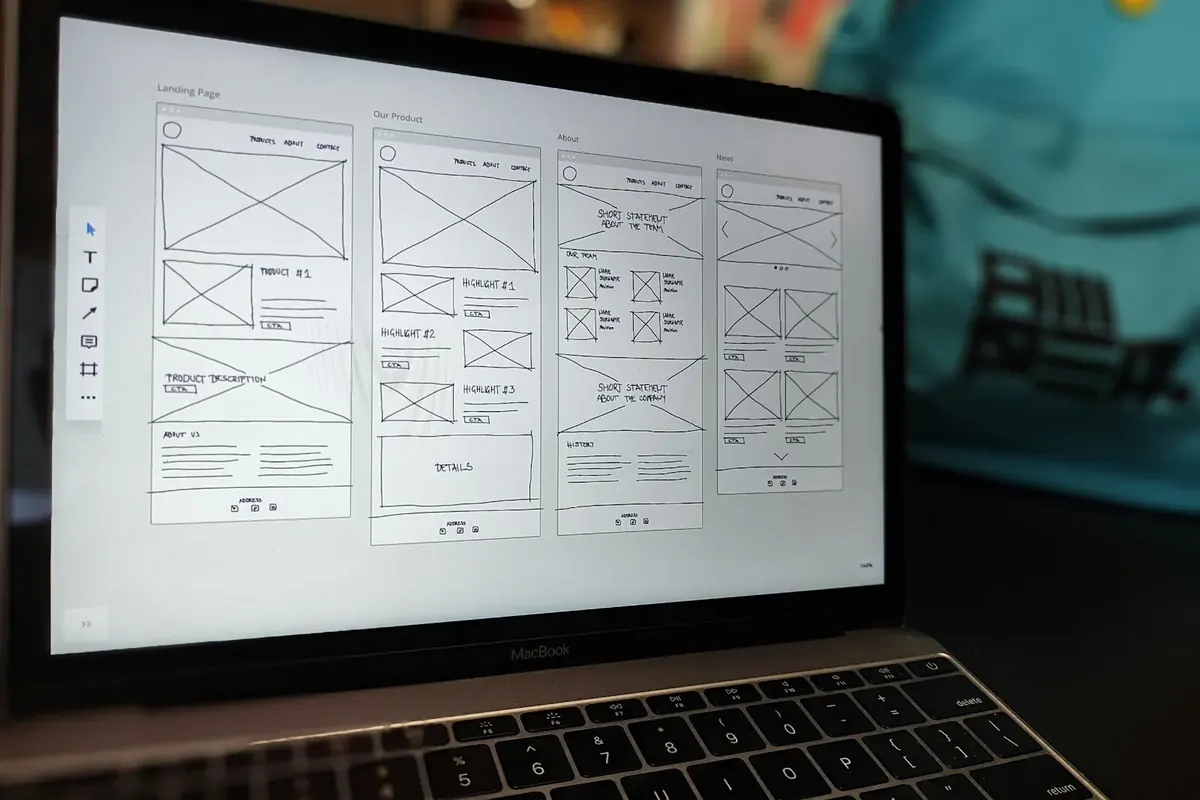Un portátil en un estudio oscuro muestra el diseño de una web hecha con bloques prediseñados.